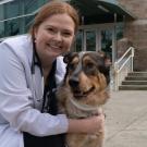 Veterinarian and dog in front of a buiding